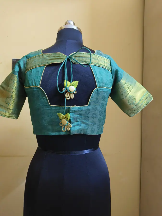 Sea-green silk, gold zari border, tasseled ties