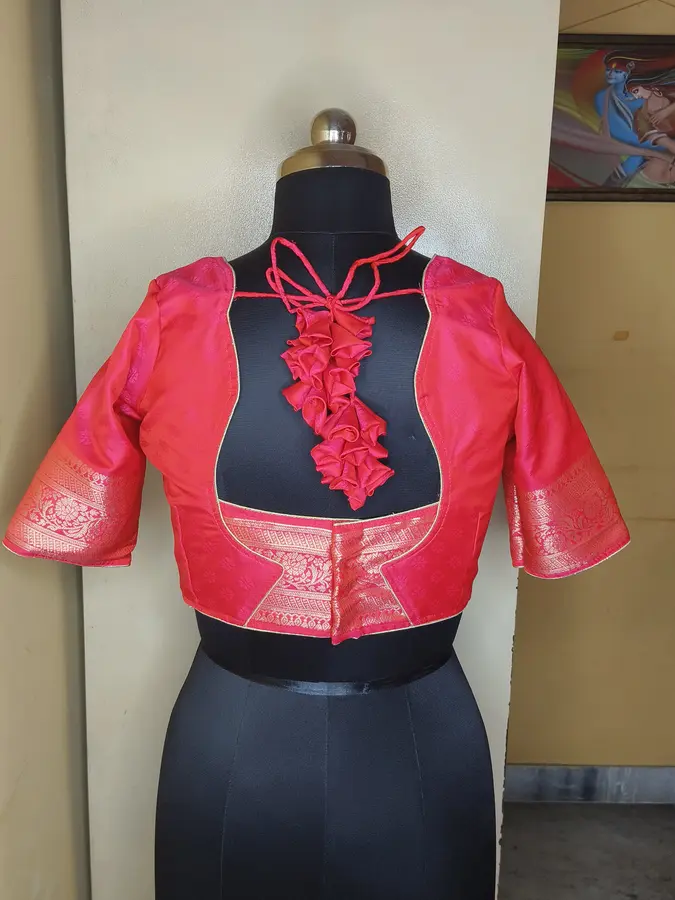 Rose-red silk, cascading ruffle detail at the front